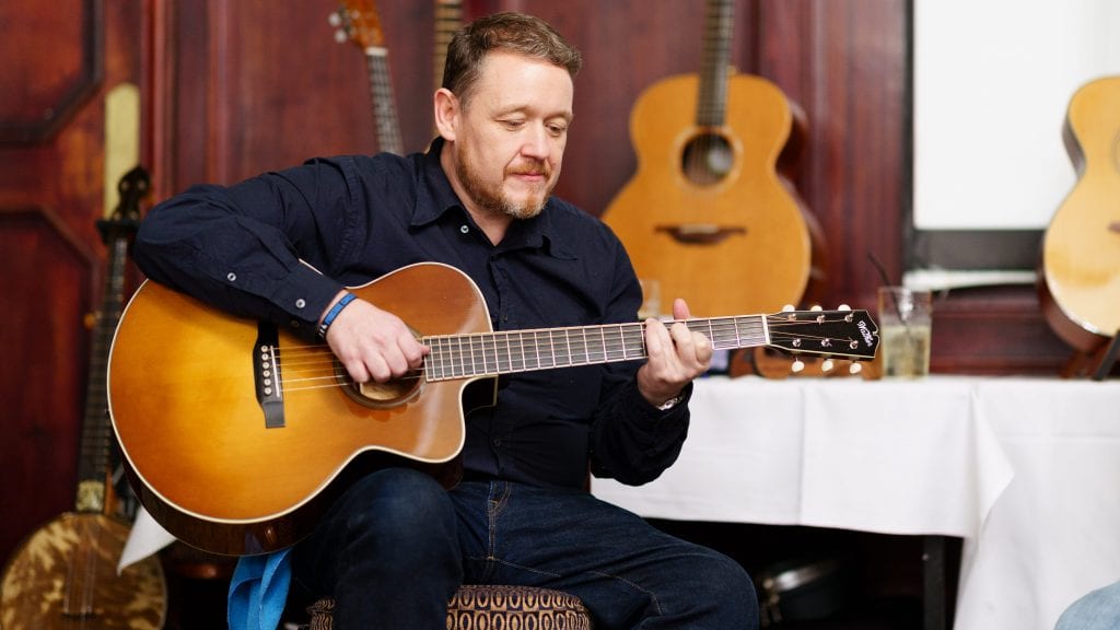 Martin Robertson playing guitar at the Halifax gathering