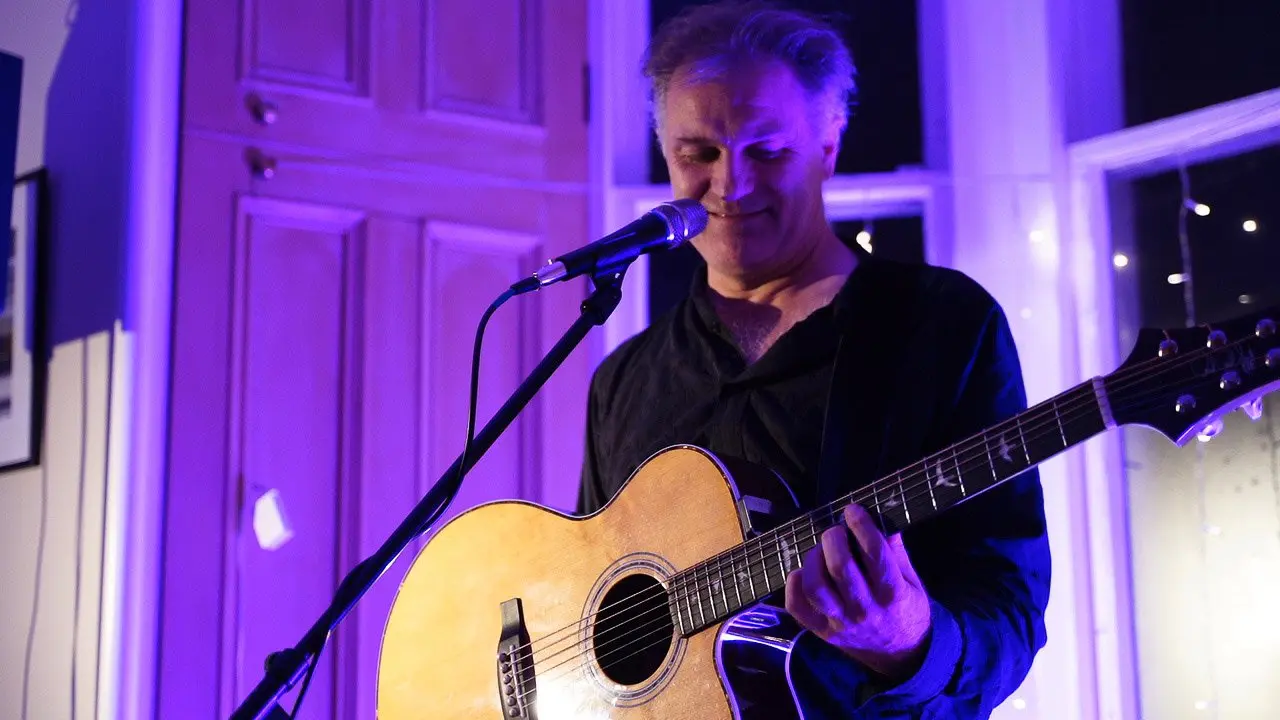 Nick Harper playing a house concert in Glasgow